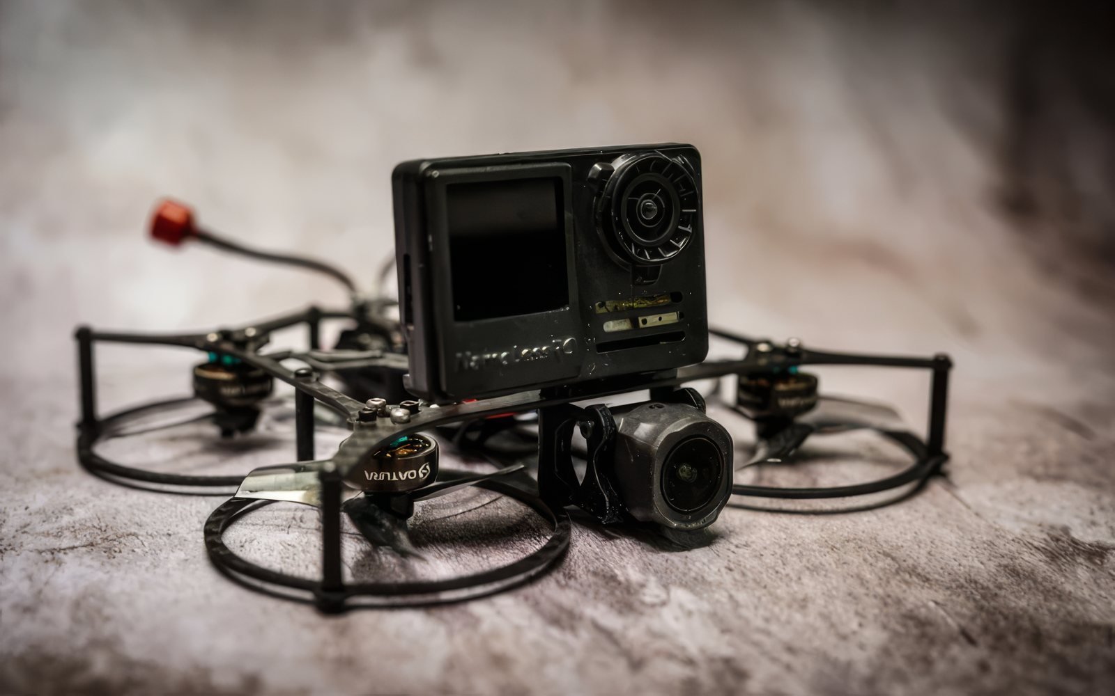 The SnapRing 2.5-inch cinewhoop by Drone Co Productions, full-ring prop guards and an action camera on the top plate